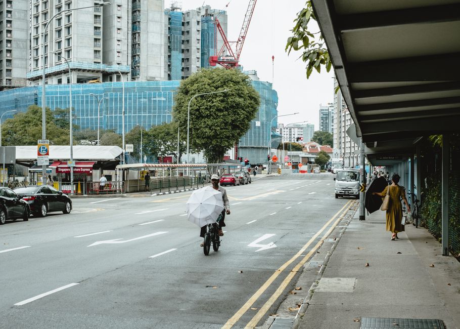 A bustling street scene with construction in Singapore featuring buildings and pedestrians.
